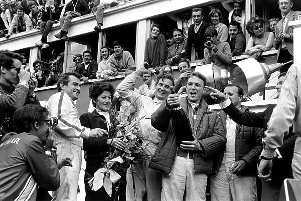 1967 Le Mans 24 hours: Dan Gurney and AJ Foyt, celebrate finishing in 1st position with Ludovico Scarfiotti and Mike Parks, 2nd position