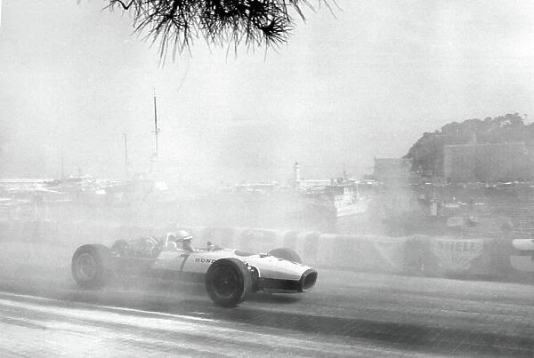 1967 Monaco Grand Prix. Monte Carlo, Monaco. 7 May 1967. John Surtees, Honda RA273, retired, through the smoke caused by Bandini's accident, action. World Copyright: LAT Photographic Ref: Autosport b&w print