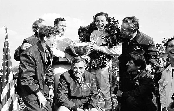 1967 United States Grand Prix. Watkins Glen, New York, USA. 29 / 9-1 / 10 1967. Walter Hayes, Graham Hill and Jim Clark (both Team Lotus) celebrate the team's