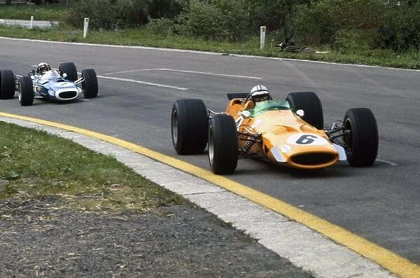1968 Belgian Grand Prix: Denny Hulme, McLaren M7A-Ford, retired, leads Jackie Stewart, Matra MS10-Ford, 4th position, action
