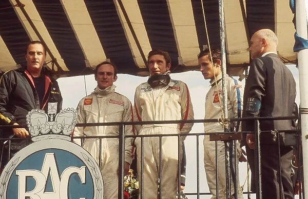1968 British Grand Prix: Jo Siffert 1st position, his maiden Grand Prix win. Chris Amon 2nd position and Jacky Ickx 3rd position on the podium