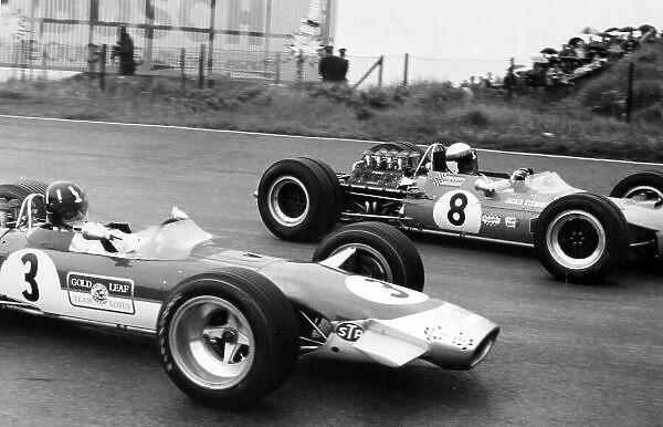1968 Dutch Grand Prix. Zandvoort, Holland. 23 June 1968. Graham Hill, #3 Lotus 49B-Ford, 9th position, and Jackie Stewart, #8 Matra MS10-Ford, 1st position, action. World Copyright: LAT Photographic Ref: Motor b&w print