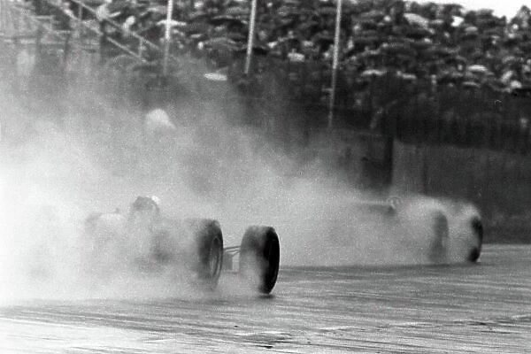 1968 Dutch Grand Prix. Zandvoort, Holland. 23 June 1968. Graham Hill, Lotus 49B-Ford, 9th position, leads Richard Attwood, BRM P126, 7th position, in the rain, action. World Copyright: LAT Photographic Ref: Motor b&w print