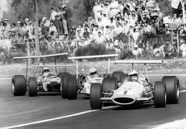 1968 Mexican Grand Prix: Denny Hulme, McLaren M7A-Ford, retired, leads John Surtees, Honda RA301, retired, and Jack Brabham, Brabham BT26-Repco