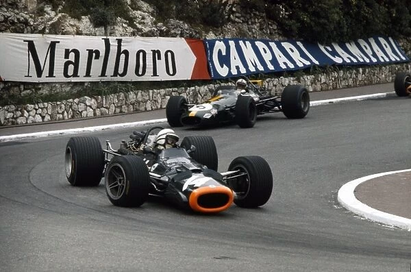 1969 Monaco Grand Prix: John Surtees, B. R. M. P138, retired, leads Jack Brabham, Brabham BT26-Ford, retired, action