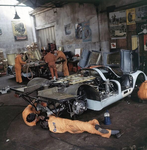 1970 Le Mans 24 Hours: Gulf Porsche Team work on a Porsche 917 in their garage