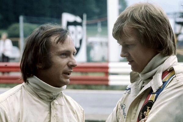 1974 Formula 1 World Championship: Ronnie Peterson chats to Chris Amon in the pits, portrait