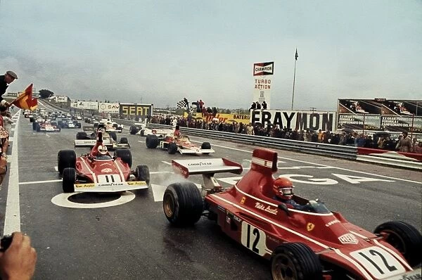 1974 Spanish Grand Prix: Niki Lauda, 1st position, leads Clay Regazzoni, 2nd position and Emerson Fittipaldi 3rd position, at the start of the race