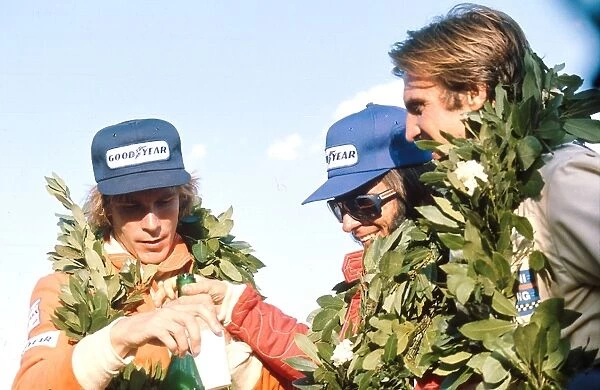 1975 Argentinian Grand Prix: Emerson Fittipaldi 1st position, James Hunt 2nd position and Carlos Reutemann 3rd position on the podium