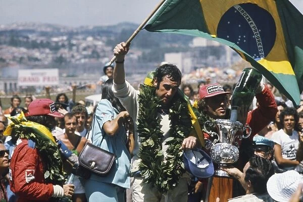 1975 Brazilian Grand Prix - Podium: Carlos Pace 1st position, celebrates winning his home Grand Prix, taking his maiden and only win. Emerson Fittipaldi