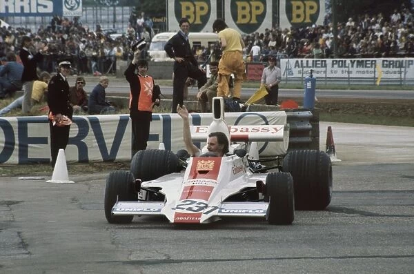 1975 British Grand Prix - Graham Hill: Graham Hill, Embassy Hill GH1 Ford, waves to the crowd during a demonstration lap