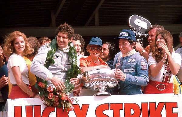 1975 South African Grand Prix. Kyalami, South Africa. 27 / 2-1 / 3 1975. Jody Scheckter (Tyrrell Ford) 1st position with teammate Patrick Depailler (Tyrrell Ford) 3rd position on the podium. Ref-75 SA 03. World Copyright - LAT Photographic