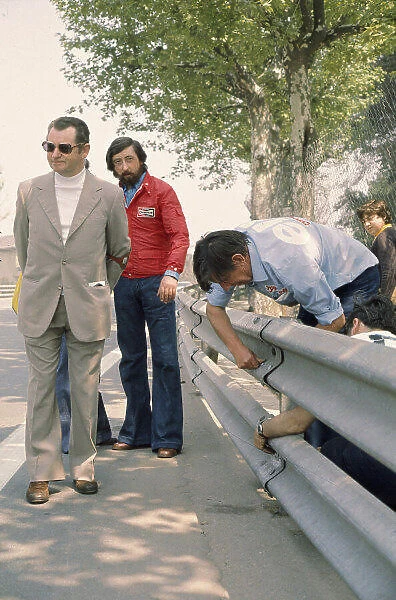 1975 Spanish Grand Prix. Monjuich Park, Spain. 25-27 April 1975. Ken Tyrrell examines the armco barriers, which were the subject of concern causing a driver protest. Ref-75 ESP 03. World Copyright - LAT Photographic