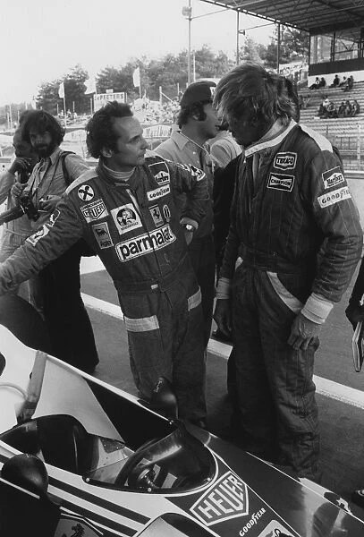 1976 Belgian Grand Prix: James Hunt, in conversation with Niki Lauda, portrait