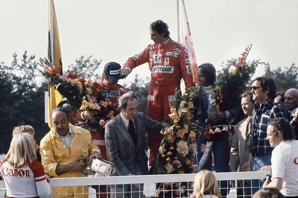 1976 Belgian Grand Prix - Podium: Niki Lauda, 1st position, celebrates with Clay Regazzoni, 2nd position and Jacques Laffite, 3rd position on the podium