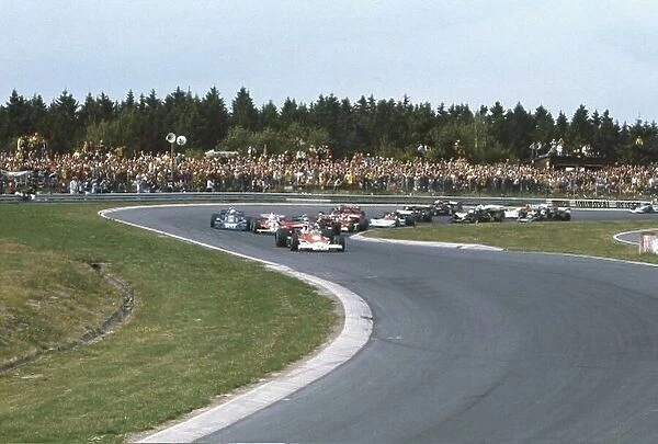 1976 German Grand Prix. Nurburgring, Germany. 30th July -1st August 1976. James Hunt (McLaren M23 Ford) leads the rest of the field at the start. World Copyright - LAT Photographic