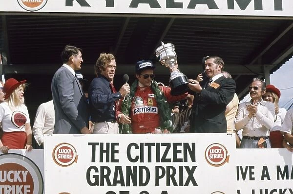 1976 South African Grand Prix - Podium: Niki Lauda, Ferrari, receives the winners trophy on the podium