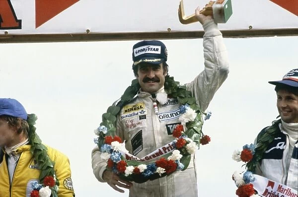 1979 British Grand Prix: Clay Regazzoni, 1st position and Rene Arnoux, 2nd position with Jean-Pierre Jarier, 3rd position, celebrate on the podium