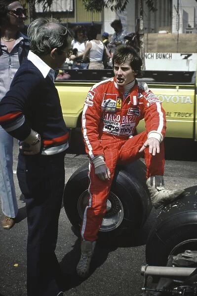 1979 United States Grand Prix West: Gilles Villeneuve 1st position, relaxes in the pits, portrait
