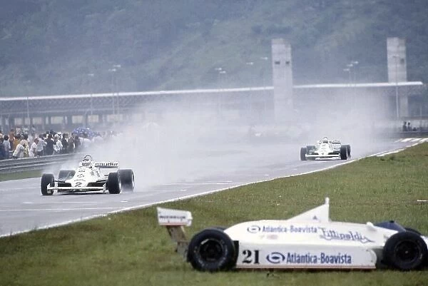 1981 Brazilian Grand Prix. Jacarepagua, Rio de Janeiro, Brazil. 27-29 March 1981. Carlos Reutemann leads Alan Jones (both Williams FW07C-Ford Cosworth) passed the retired Chico Serra (Fittipaldi F8C-Ford Cosworth)