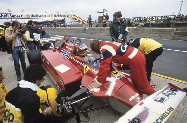 1981 British Grand Prix: Gilles Villeneuve, retired, in conversation with teammate Didier Pironi, in the pits, portrait