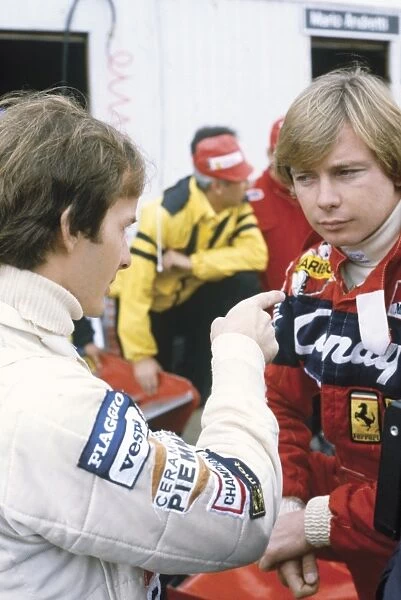 1981 Canadian Grand Prix: Gilles Villeneuve, Ferrari, in conversation with teammate, Didier Pironi. Ref: 81CAN38. World