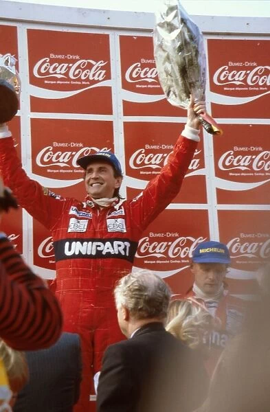 1982 Belgian Grand Prix: John Watson 1st position, with teamate Niki Lauda, 3rd position next to him on the podium