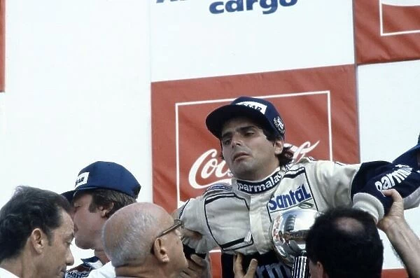 1982 Brazilian Grand Prix. Rio de Janeiro, Brazil. 21 March 1982. Nelson Piquet, Brabham BT49D-Ford, disqualified, collapses exhausted on the podium after winning on the road