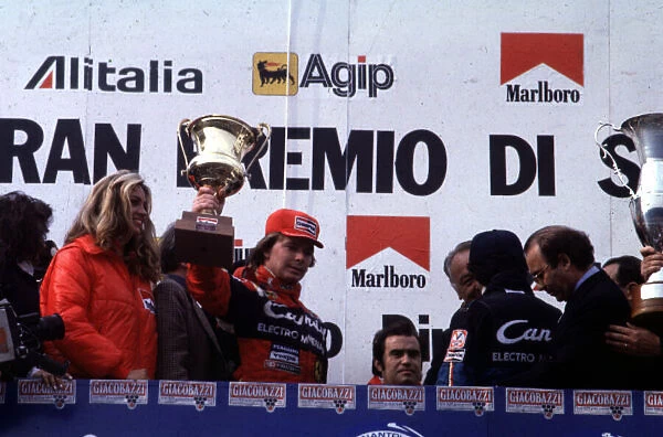 1982 SAN MARINO GP. Didier Pironi lifts his victory trophy after beating his team mate