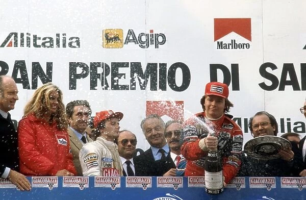 1982 San Marino Grand Prix: Didier Pironi 1st position celebrates on the podium with teammate Gilles Villeneuve 2nd position behind