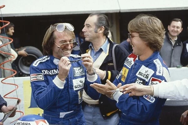 1983 French Grand Prix: Keke Rosberg watches team mate Jacques Lafitte try on some sun glasses