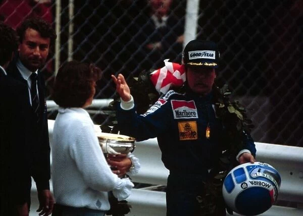 1983 MONACO GP. Keke Rosberg and his girlfriend Yvonne leave the podium after winning the race in the rain. Photo: LAT