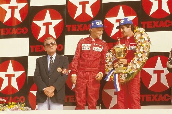 1984 Dutch Grand Prix: Alain Prost, 1st position with teammate Niki Lauda, 2nd position on the podium with FIA President Jean-Marie Balestre