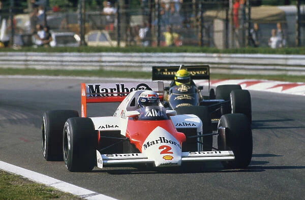 1985 Italian Grand Prix. Monza, Italy. 6th - 8th September 1985. Alain Prost (McLaren MP4 / 2B-TAG Porsche) 1st position, leads Ayrton Senna (Lotus 97T-Renault) 3rd position, action. World Copyright: LAT Photographic. Ref: 85ITAc