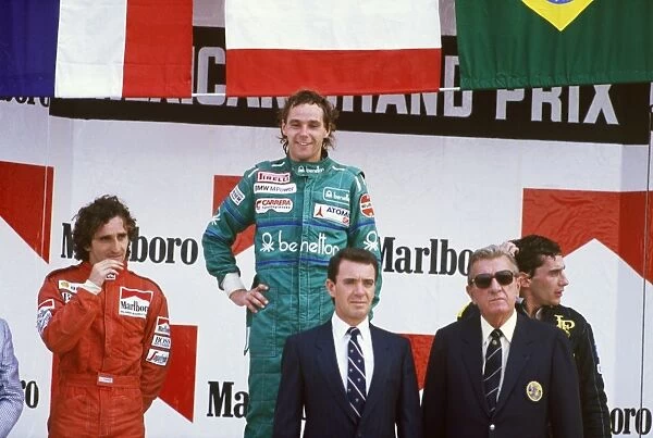 1986 Mexican Grand Prix: Gerhard Berger 1st position, Alain Prost, 2nd position, and Ayrton Senna, 3rd position, on the podium with Jean Marie