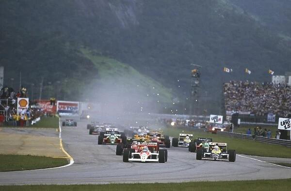 1988 Brazilian Grand Prix: Alain Prost, 1st position, followed by Nigel Mansell, retired, and Gerhard Berger, 2nd position, at the start, action