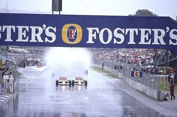1989 Australian Grand Prix. Adelaide, Australia. 3-5 November 1989. Ayrton Senna and Alain Prost (Both McLaren MP4 / 5 Honda's) kick up the spray as they both head down to the first turn together side by side at the start. Ref-89 AUS 11. World