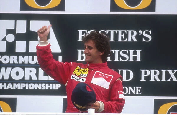 1990 British Grand Prix. Silverstone, England. 13-15 July 1990. Alain Prost (Ferrari) celebrates his 1st position on the podium. Ref-90 GB 05. World Copyright - LAT Photographic