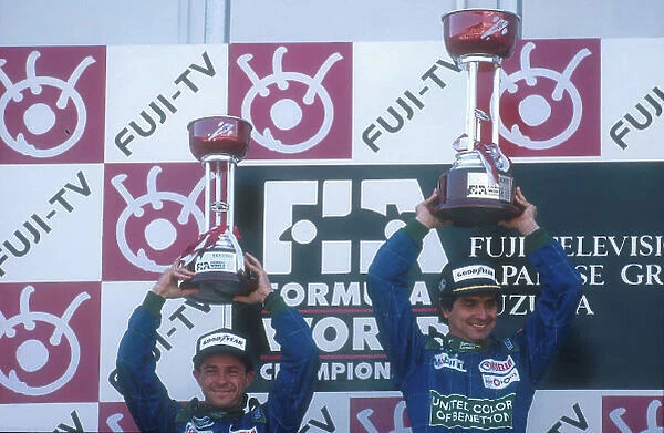 1990 Japanese Grand Prix. Suzuka, Japan. 19-21 October 1990. Nelson Piquet (Benetton Ford) celebrates his 1st position with teammate Roberto Moreno, 2nd position on the podium. Ref-90 JAP 19. World Copyright - LAT Photographic