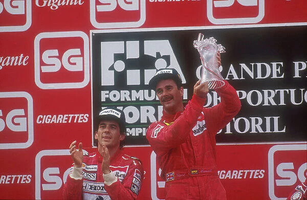 1990 Portuguese Grand Prix. Estoril, Portugal. 21-23 September 1990. Nigel Mansell (Ferrari) celebrates 1st position on the podium, with Ayrton Senna (McLaren Honda) 2nd position next to him. Ref-90 POR 02. World Copyright - LAT Photographic