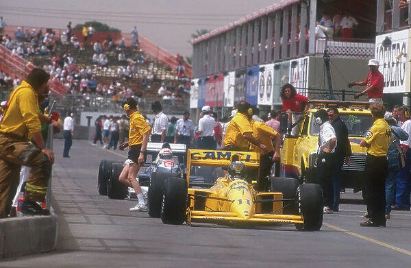 1990 United States Grand Prix. Phoenix, Arizona, USA. 9-11 March 1990. Derek Warwick (Lotus 102 Lamborghini) with Satoru Nakajima (Tyrrell 018 Ford) behind, leaving the pits