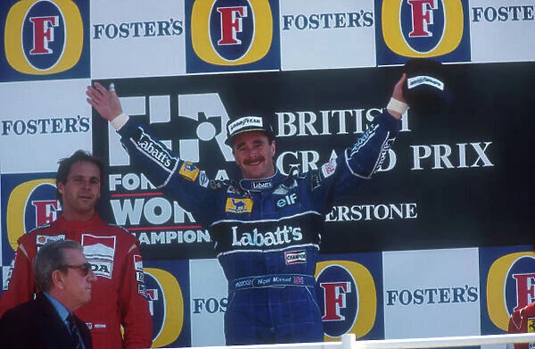 1991 British Grand Prix. Silverstone, England. 12-14 July 1991. Nigel Mansell (Williams Renault) celebrates 1st position on the podium, with Gerhard Berger (McLaren Honda) 2nd position