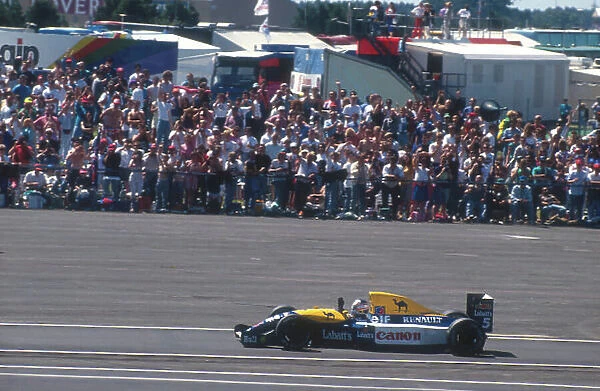 1991 British Grand Prix. Silverstone, England. 12-14 July 1991. Nigel Mansell (Williams FW14 Renault) 1st position, acknowledges the crowds applause. Ref-91 GB 16. World Copyright - LAT Photographic