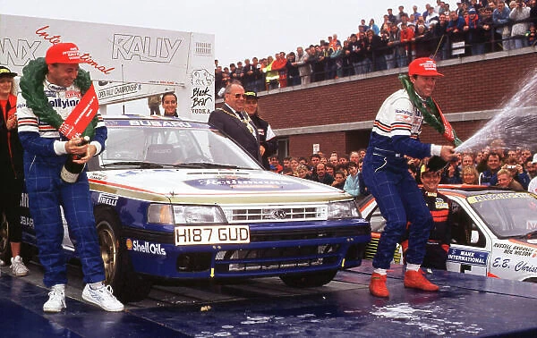1991 British Rally Championship. Manx Rally, Great Britain. Colin McRae / Derek Ringer (Subaru Legacy RS) Ist position. McRae and Ringer celebrate on the podium, they won the British title the same year. World LAT Photographic