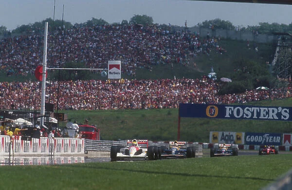 1991 Hungarian Grand Prix. Hungaroring, Hungary. 9-11 August 1991. Ayrton Senna (McLaren MP4 / 6 Honda) leads Nigel Mansell, Riccardo Patrese (both Williams FW14 Renault's) and Alain Prost (Ferrari 643)