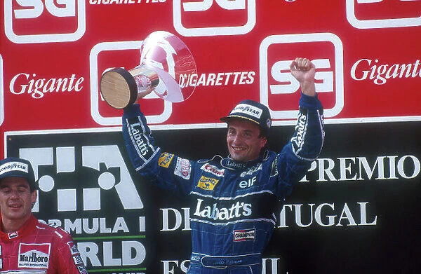 1991 Portuguese Grand Prix. Estoril, Portugal. 20-22 September 1991. Riccardo Patrese (Williams Renault) celebrates 1st position on the podium. Ayrton Senna (McLaren Honda)
