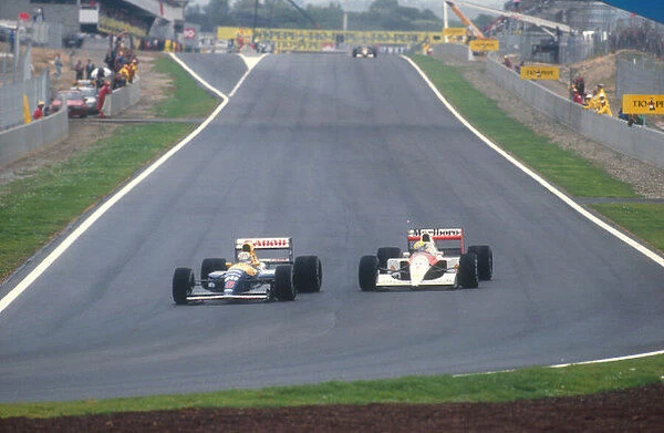 1991 Spanish Grand Prix. Barcelona, Spain. 27-29 September 1991. Nigel Mansell (Williams FW14 Renault) overtakes Ayrton Senna (McLaren MP4  /  6 Honda) into turn 1