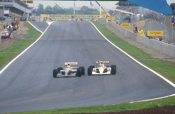1991 Spanish Grand Prix. Barcelona, Spain. 27-29 September 1991. Nigel Mansell (Williams FW14 Renault) overtakes Ayrton Senna (McLaren MP4 / 6 Honda) into turn 1