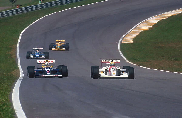 1992 Brazilian Grand Prix. Interlagos, Sao Paulo, Brazil. 3-5 April 1992. Ayrton Senna (McLaren MP4 / 7A Honda) alongside Nigel Mansell (Williams FW14B Renault) during qualifying. Ref-92 BRA 10. World Copyright - LAT Photographic
