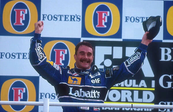 1992 British Grand Prix. Silverstone, England. 10-12 July 1992. Nigel Mansell (Williams FW14B Renault) celebrates 1st position on the podium. Ref-92 GB 17. World Copyright - LAT Photographic